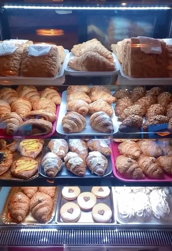 The display case full of croissants and brioche