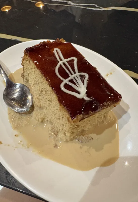 A slice of trileçe with caramel glaze in milk